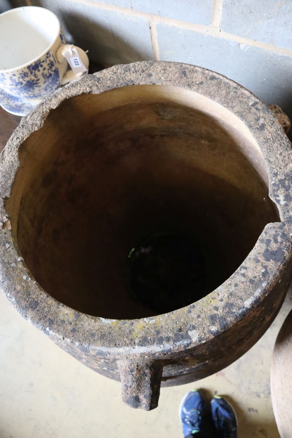 A pair of three-handled terracotta oil jars, each with ribbed sides and narrow foot, height 100cm (faults)